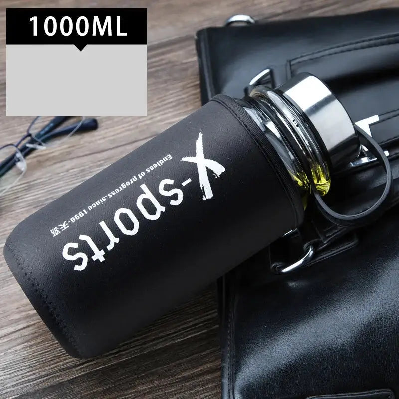 Modern black glass tea bottle with matte silicone sleeve and white x-sports branding for kitchen and travel use