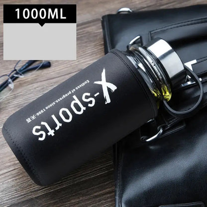 Modern black glass tea bottle with matte silicone sleeve and white x-sports branding for kitchen and travel use