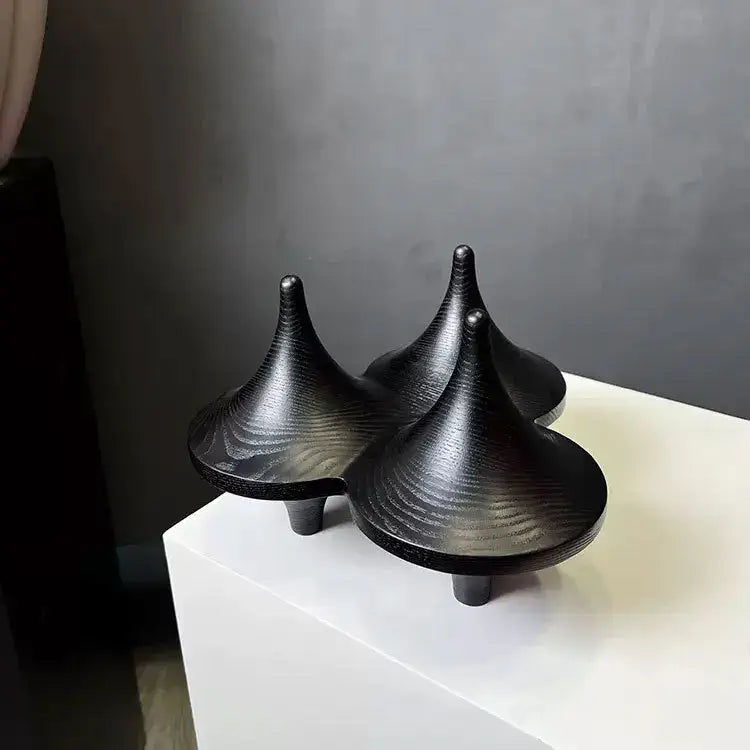 Three sleek black ceramic decorbites geometric gyroscope sculptures with glossy finish and concentric grooves for living room decor