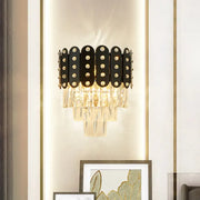 Modern black and gold 3-tiered wall-mounted light with clear faceted crystal oval panels and sparkling rhinestones