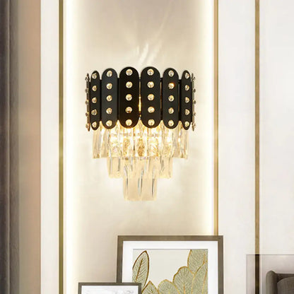 Modern black and gold 3-tiered wall-mounted light with clear faceted crystal oval panels and sparkling rhinestones
