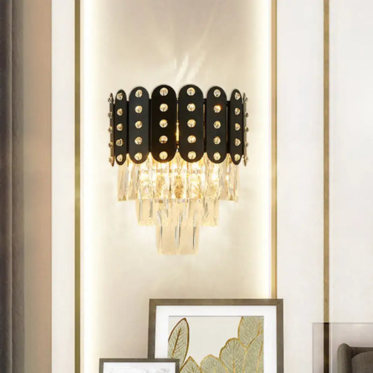 Modern black and gold 3-tiered wall-mounted light with clear faceted crystal oval panels and sparkling rhinestones