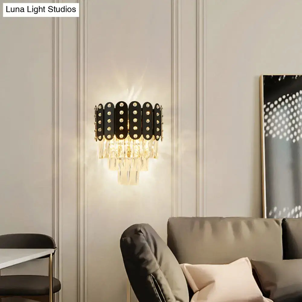 Modern black and gold 3-tiered wall-mounted light with clear faceted crystal droplets and circular embellishments
