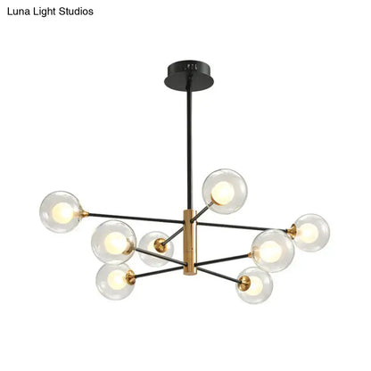 Modern black and brass DecorBites™ chandelier offers clear glass globe bulbs with an 8-light fixture width for living rooms