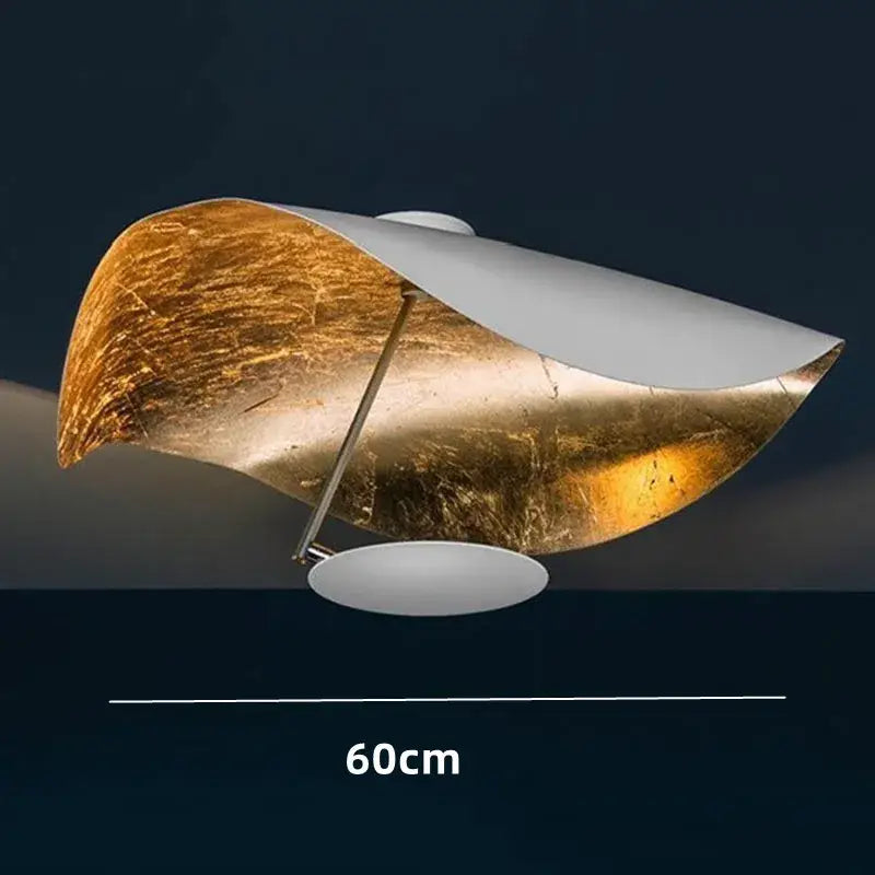 A modern black and gold pendant lamp with asymmetrical gold leaf and white metal design for dining room decorbites lederam manta
