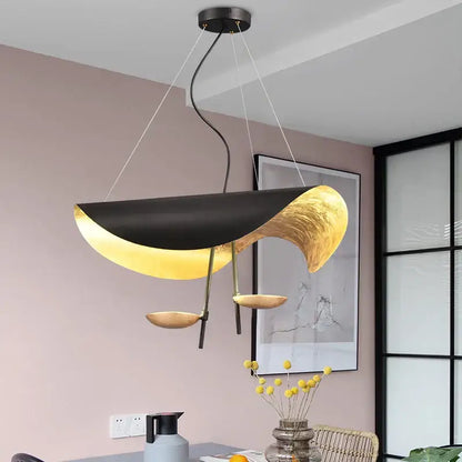Modern black and gold abstract lederam manta pendant light with sculptural flowing design for dining room decorbites lederam
