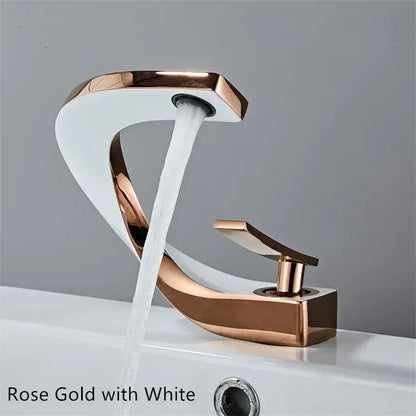 Modern black and gold basin faucet with rose gold and white waterfall spout in sleek curved design by decorbites black