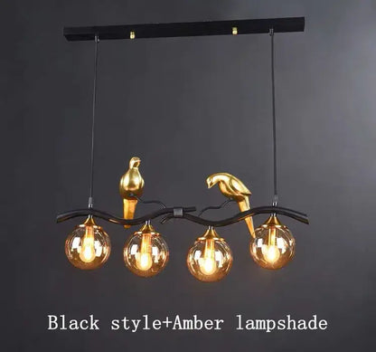 Modern black and gold bird glass pendant lights featuring a black metal chandelier with amber glass globe lampshades
