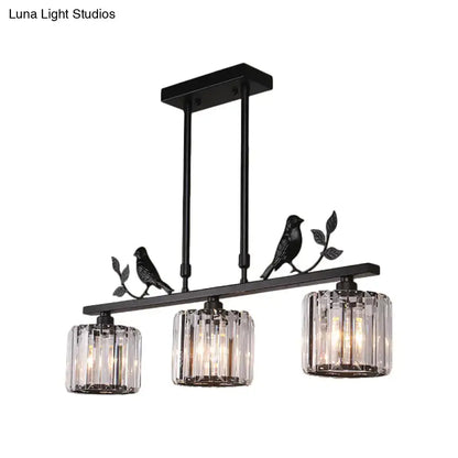 Black metal DecorBites™ chandelier with three clear crystal drum shades and black gold bird accents on a branch