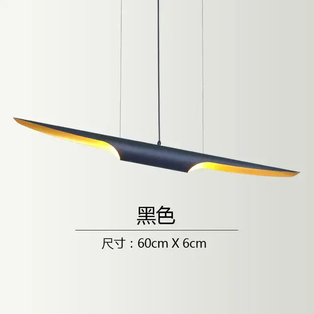 Modern black and gold blade pendant light with sleek elongated design and warm yellow lighting ideal for dining room decorbites coltrane pendant