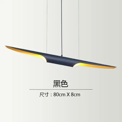 Modern black and gold blade pendant light with a sleek design and warm yellow interior for dining room decorbites coltrane pendant
