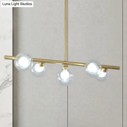 Modern black and gold ceiling light with brass fixtures and bubble clear glass bulbs for clear glass island dining room