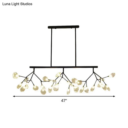Modern black metal chandelier with branching arms and clear glass teardrop pendant lights for dining room use