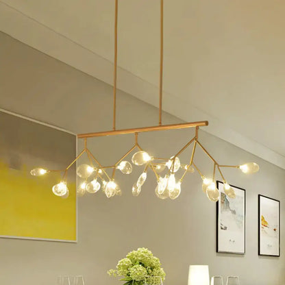 Modern black and gold dining room chandelier with clear glass bubble bulbs and a gold-toned branching metal frame
