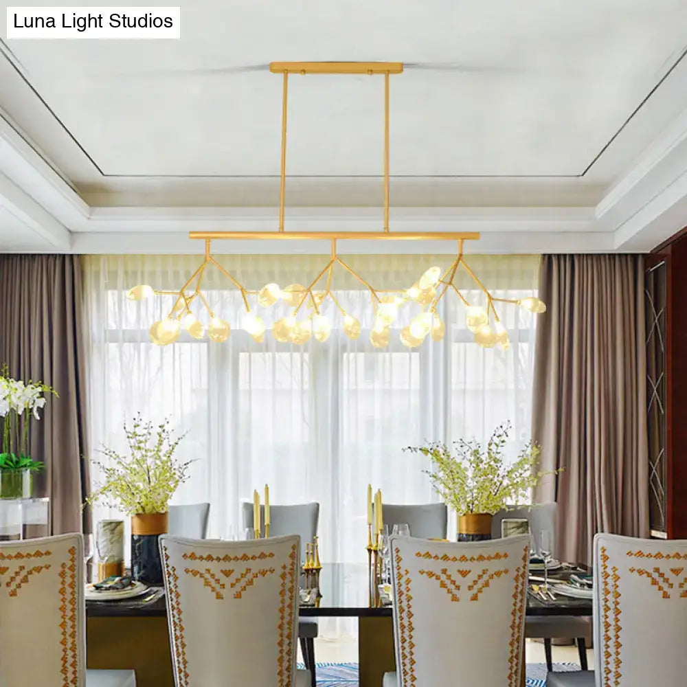 Modern black and gold dining room chandelier with gold-toned branches and clear glass frosted globe bulbs