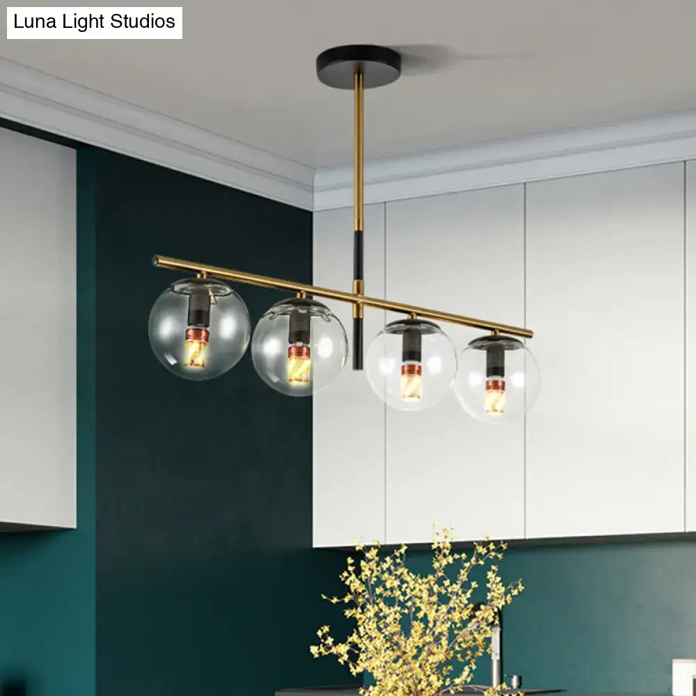 Modern black and gold pendant light with four clear glass globe shades suitable for 110v-240v and 220v-240v use