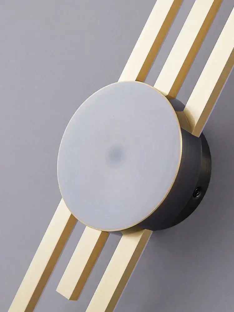 Modern black and gold copper wall light with circular frosted glass diffuser and radiating metallic rods for bedroom decorbites copper wall light