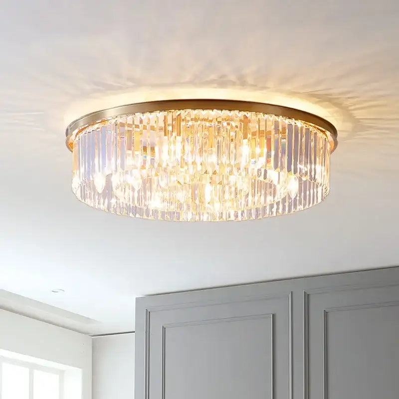 Modern black and gold pendant light with gold-toned metal finish and cascading clear crystal prisms chain pendant