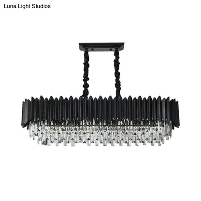 Modern black and gold crystal chandelier with elongated rectangular design featuring faceted prisms and twisted metal chains