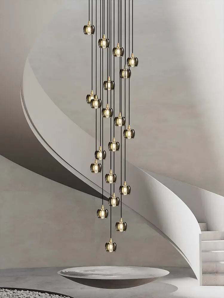 A modern black and gold crystal chandelier led pendant light with hanging golden glass globe lights on black cords