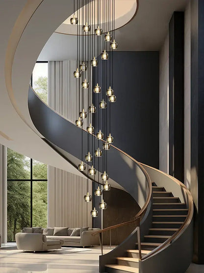 Modern black and gold crystal chandelier led pendant light illuminating a sleek dark gray spiral staircase with wooden handrails