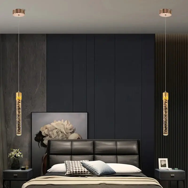 Two elegant gold-toned pendant lights with sparkling crystal rod interiors for modern dining room lighting