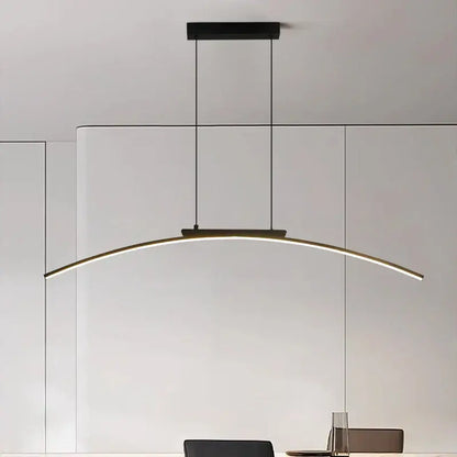 Modern black and gold curved bridge pendant light with sleek LED strip emitting warm white light for dining table