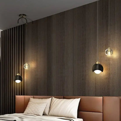 Modern black and gold decorbites crystal round chandelier with pendant lights and clear glass shades over leather headboard
