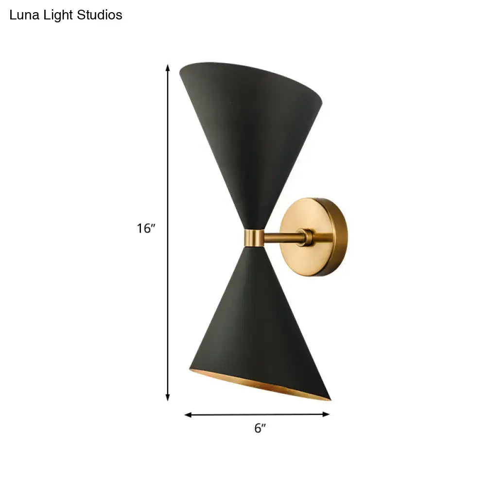Modern black wall lamp with two double cone-shaped shades gold accents and brass mounting plate for hallway use