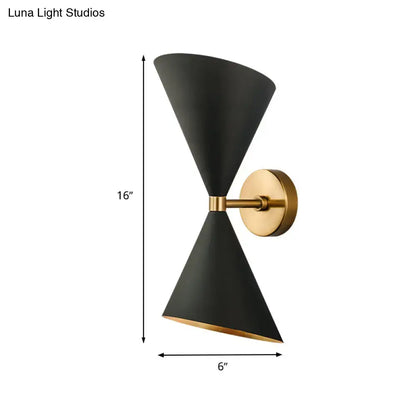 Modern black wall lamp with two double cone-shaped shades gold accents and brass mounting plate for hallway use