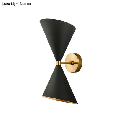 Modern black and gold wall lamp with two double cone-shaped shades in matte brass for hallway lighting