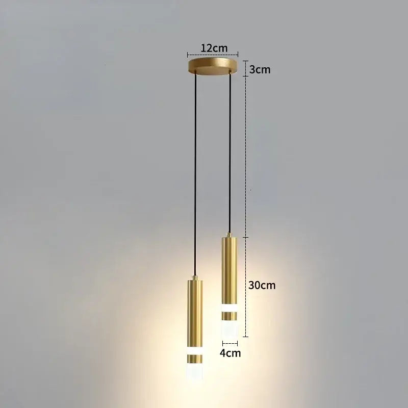 Gold-finished cylindrical pendant light with frosted glass accents for modern black and gold double spotlight in 5 square meters