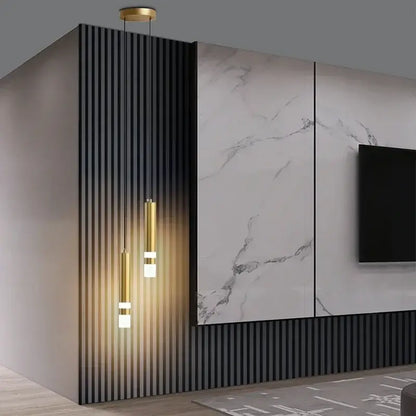 Three slender gold pendant lights with frosted glass for a modern black and gold spotlight pendant light in 5 square meters