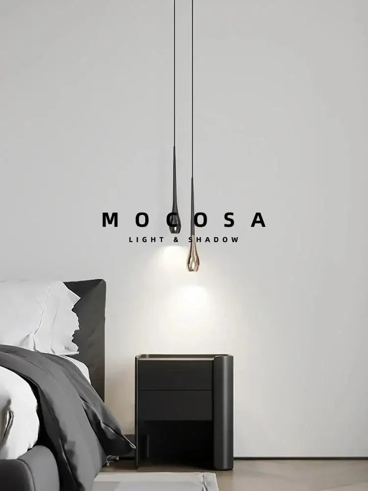Modern black and gold droplet pendant light with sleek teardrop design metallic finish and remote control for dining room