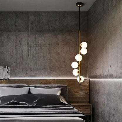 Modern black and gold glass ball pendant lights with five gold-toned spherical white glass bulbs for dining room decorbites glass ball pendant