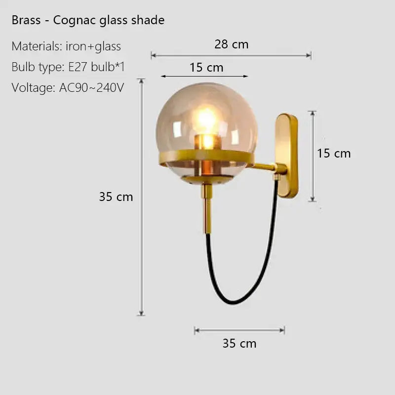 Modern black and gold brass wall sconce lamps with a spherical cognac glass shade for bedroom lighting