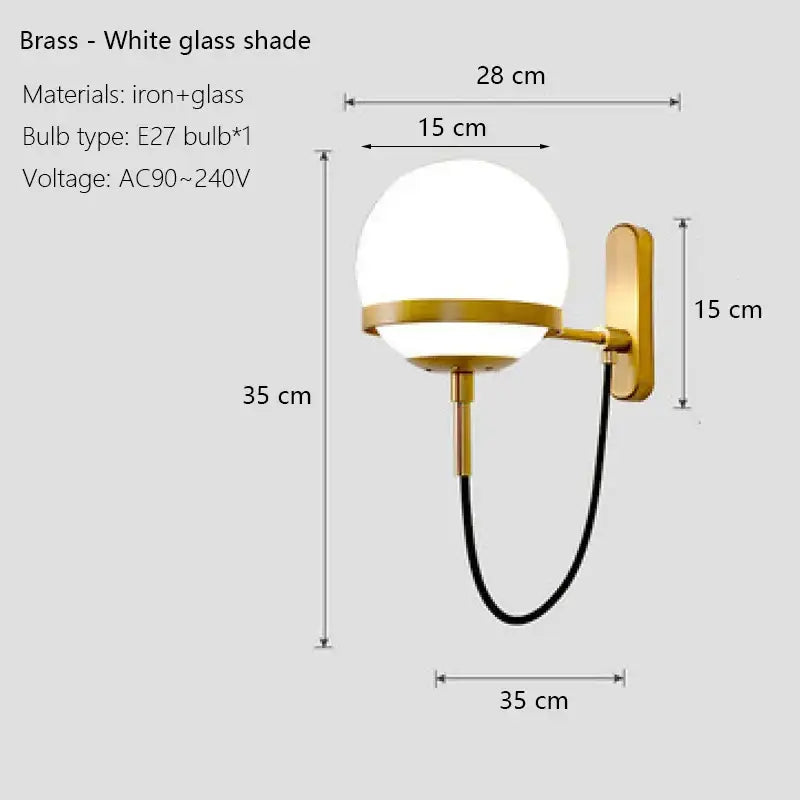 Modern black and gold wall sconce lamp with brass finish, white glass globe shade, and black cord for bedroom lighting