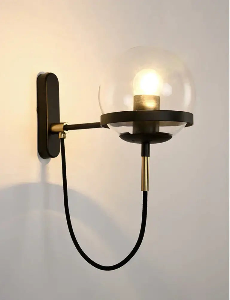 Modern black and gold glass globe wall sconce with clear glass globe and illuminated bulb ideal for bedroom lamp sconce lamps
