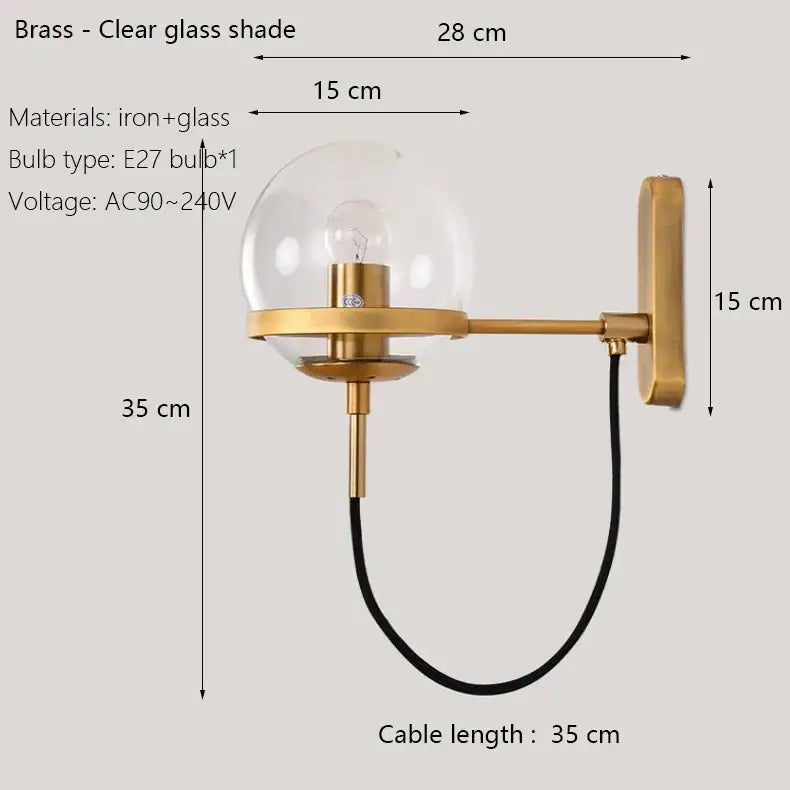 Modern black and gold wall sconce lamp with brass base and clear glass globe shade for bedroom lighting