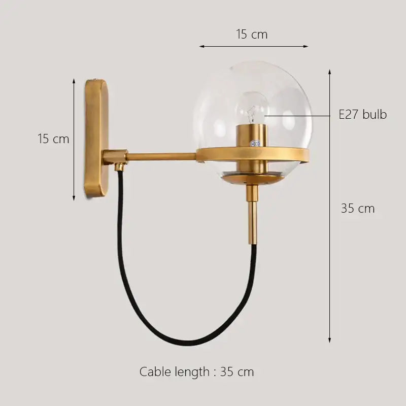Modern black and gold glass globe wall sconce lamp with clear glass globe and black cable for bedroom lighting