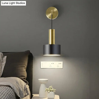 Modern black and gold grenade shaped wall lamp with brass stem and matte black shade for bedroom reading light