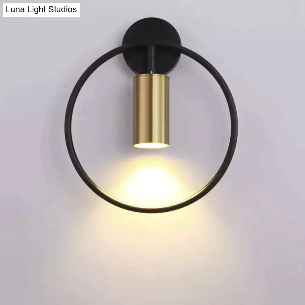 Modern black and gold irwin wall lamp with a sleek minimalist circular design for bedroom lighting