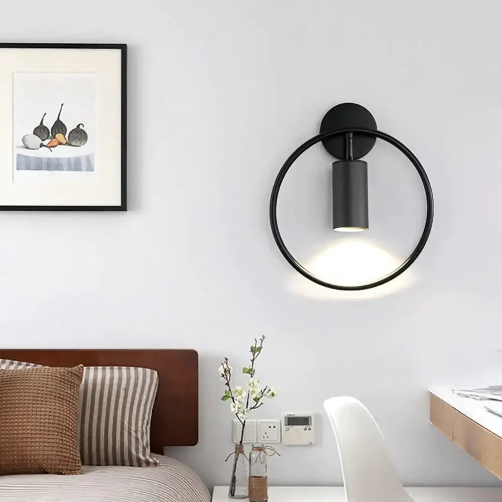 Modern black and gold irwin wall lamp featuring a sleek minimalist black circular wall sconce with matte finish