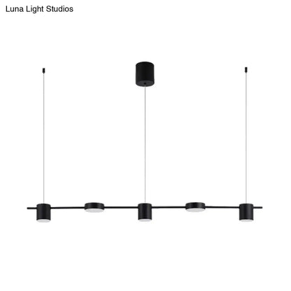 Modern black and gold ceiling light fixture with five black cylindrical LED pendants suspended by thin cables