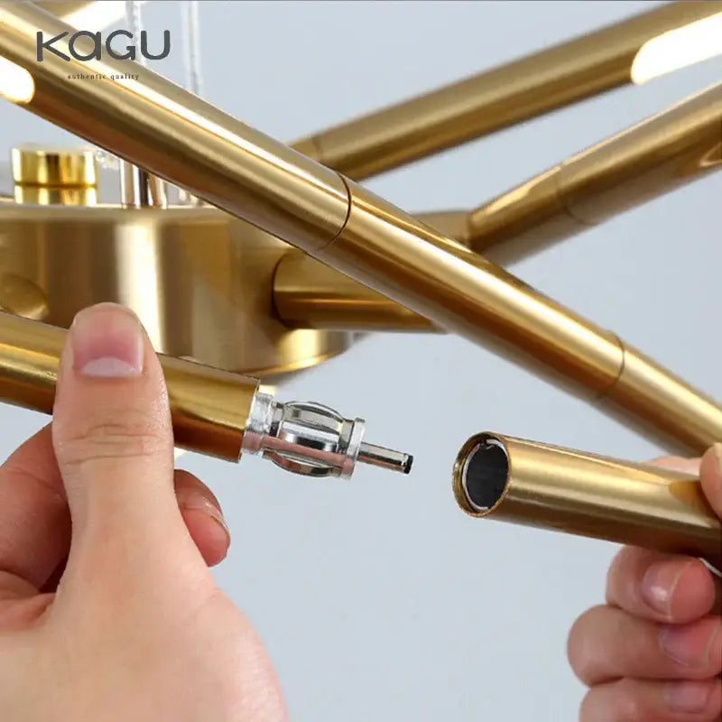 Gold-colored brass tube arm with polished finish and joint detail in decorbites black led ceiling chandelier for living room