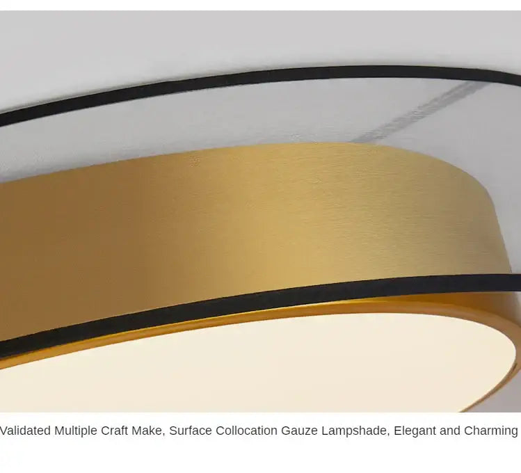 Gold-colored cylindrical lampshade with black trim on modern black and gold led ceiling light for living room