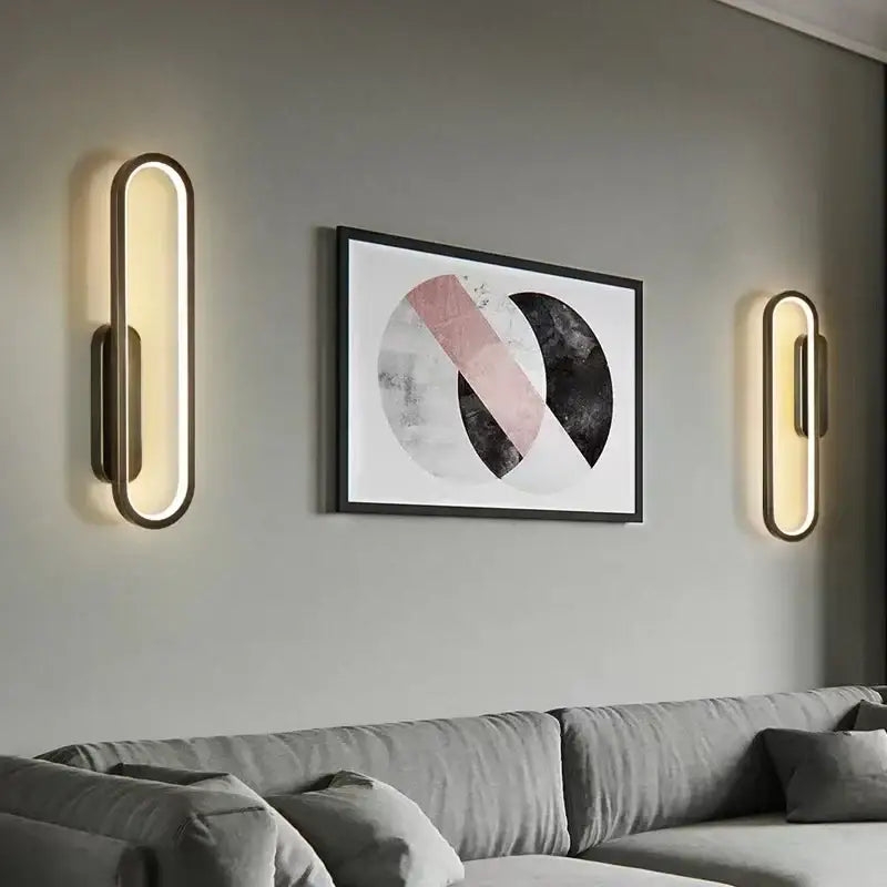 Modern black and gold led indoor wall light with gold-toned oval sconces and warm led lighting decorbites black