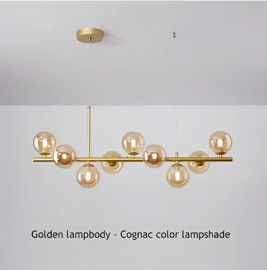 Modern black led pendant chandelier featuring spherical cognac glass lampshades on a polished brass frame for living room