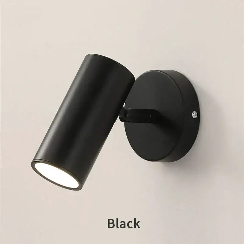 Modern black led wall lamp with cylindrical matte finish and adjustable head for bedroom use
