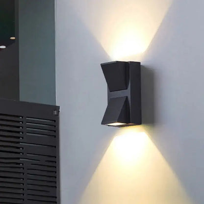 Modern black and gold led wall lamp with sleek angular geometric design casting warm light for living room decorbites led wall lamp